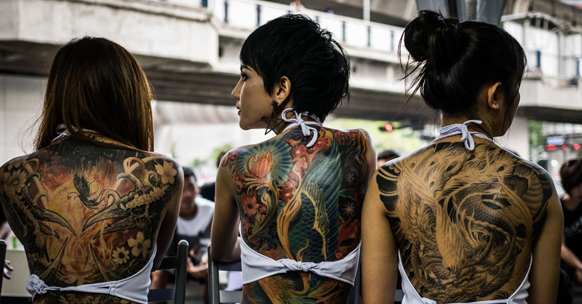 three tattooed thai women