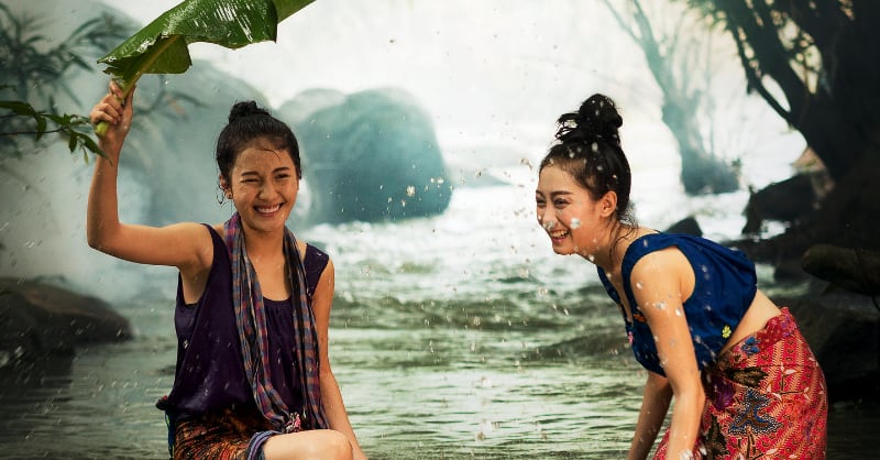 Two Udon women playing in the river