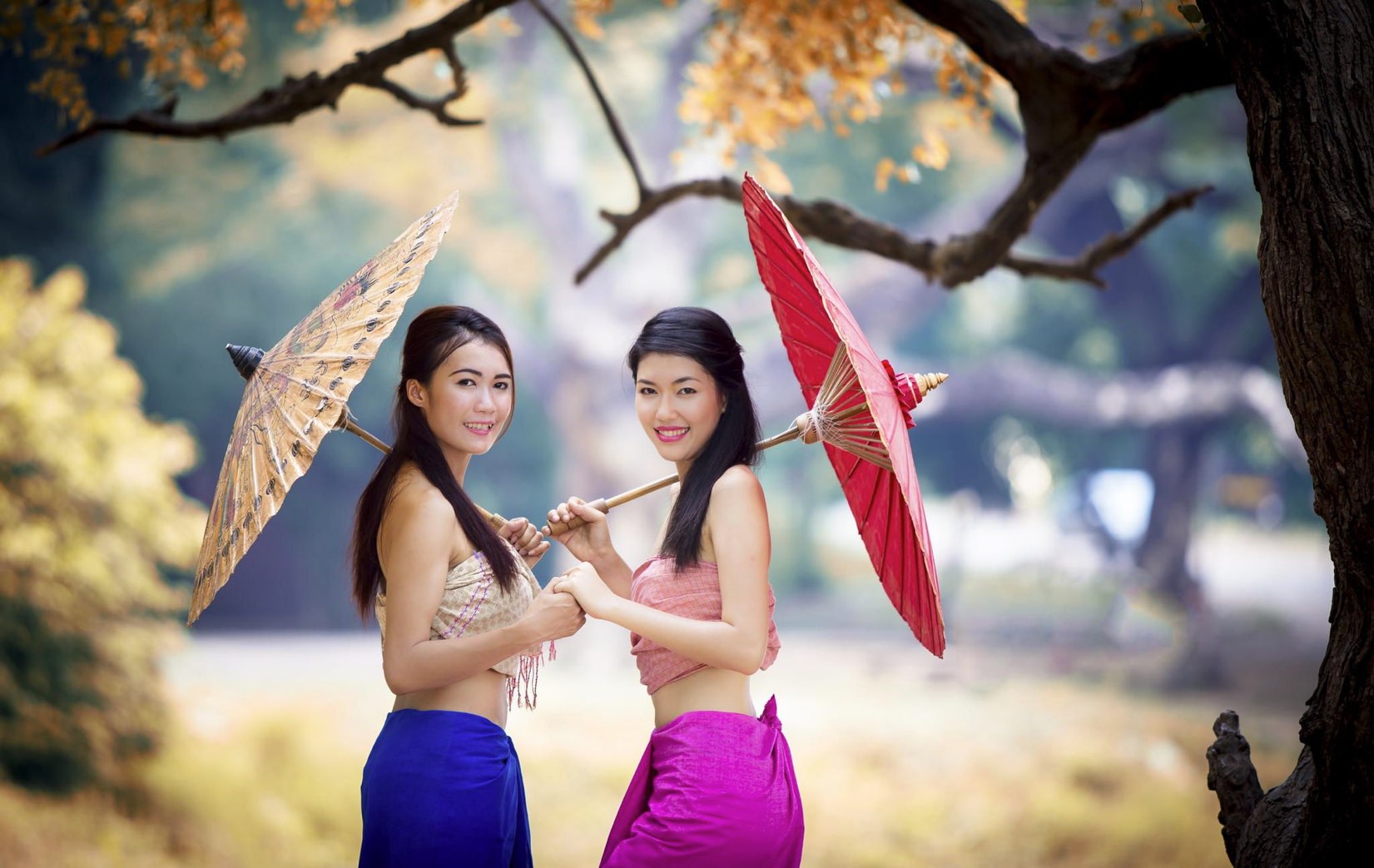 2 attractive Thai girls with umbrellas